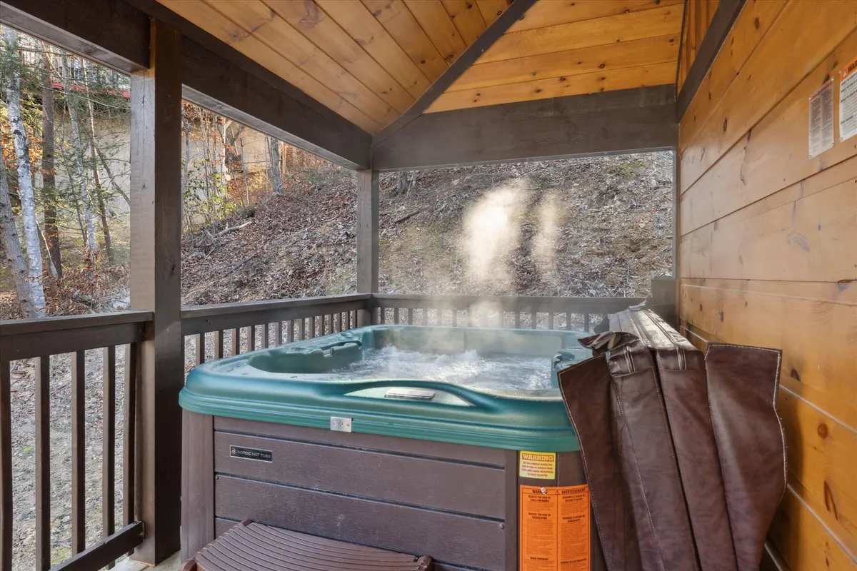 This image features a private hot tub within a cozy wooden structure, with steam rising, evoking a sense of warmth and relaxation. The tranquil and inviting mood suggests rejuvenation, and details such as the potential for stargazing or post-hike relaxation are highlighted.